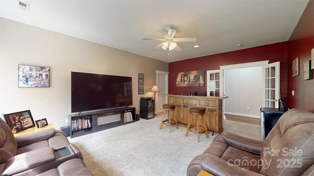 6108 Mcilwaine Rd, Huntersville, NC 28078 - living area featuring a dry bar, visible vents, carpet, and a ceiling fan