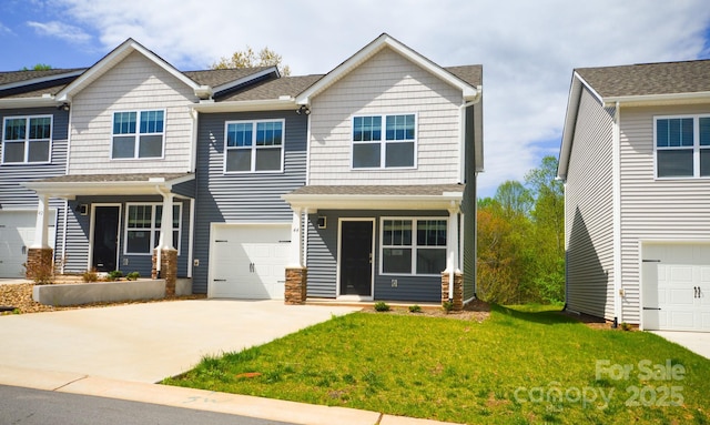 view of front facade with an attached garage, a front lawn, and driveway