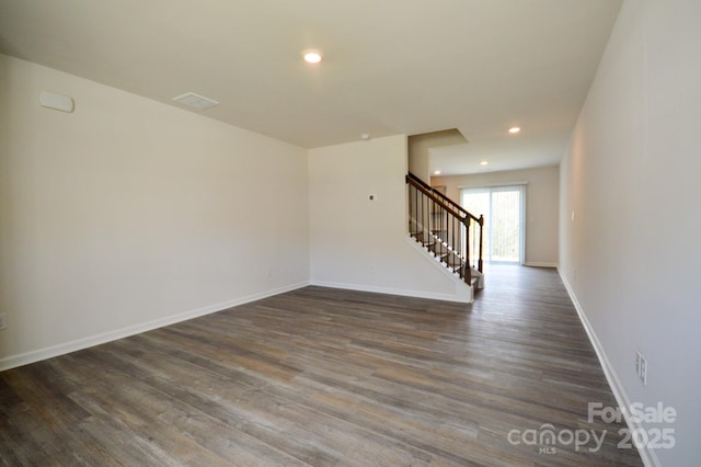 unfurnished room featuring recessed lighting, stairway, and dark wood-style floors