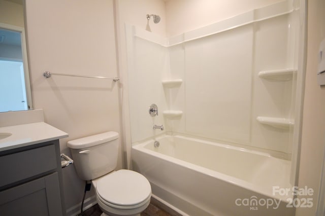 bathroom with toilet, vanity, and tub / shower combination
