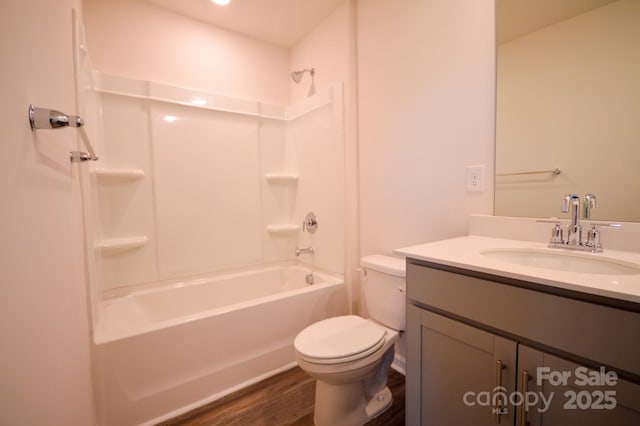 full bath featuring shower / bath combination, wood finished floors, vanity, and toilet