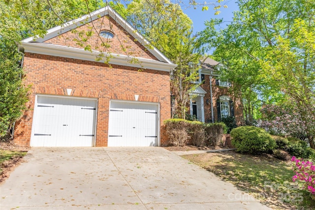 19113 Southport Dr, Cornelius, NC 28031 - view of front of home featuring an attached garage, brick siding, and concrete driveway