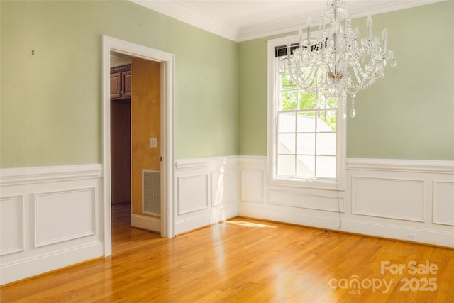 19113 Southport Dr, Cornelius, NC 28031 - unfurnished dining area featuring light wood finished floors, a notable chandelier, visible vents, and a wainscoted wall