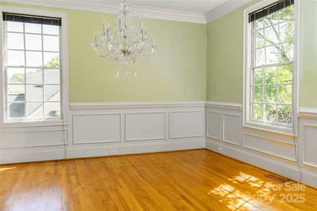 19113 Southport Dr, Cornelius, NC 28031 - unfurnished dining area with a chandelier, plenty of natural light, and light wood-type flooring