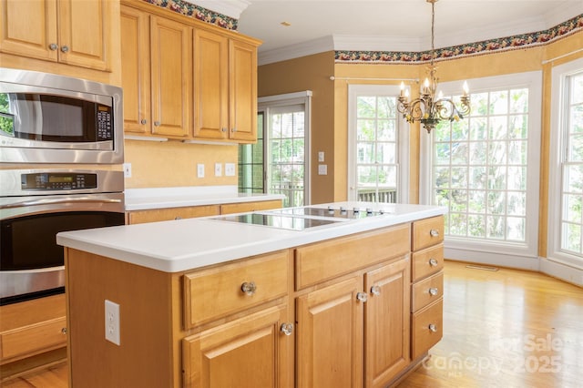 19113 Southport Dr, Cornelius, NC 28031 - kitchen featuring light wood-style flooring, a kitchen island, light countertops, stainless steel appliances, and a notable chandelier