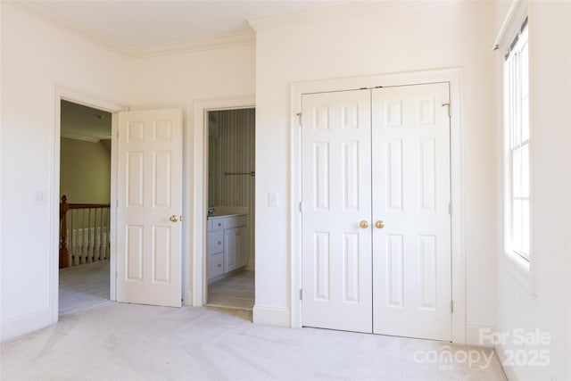 19113 Southport Dr, Cornelius, NC 28031 - unfurnished bedroom featuring a closet, baseboards, ensuite bathroom, crown molding, and light carpet