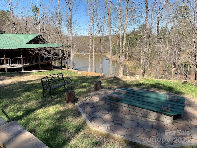 view of yard featuring a water view and a wooded view