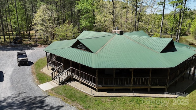 exterior space featuring a forest view