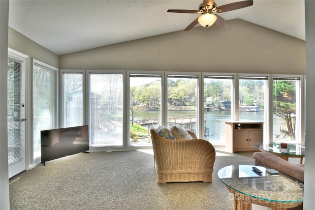 sunroom featuring plenty of natural light, vaulted ceiling, and carpet