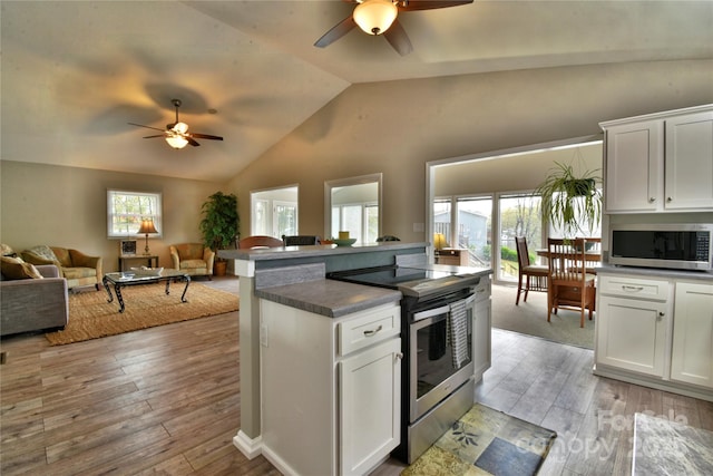 kitchen featuring open floor plan, ceiling fan, vaulted ceiling, and appliances with stainless steel finishes