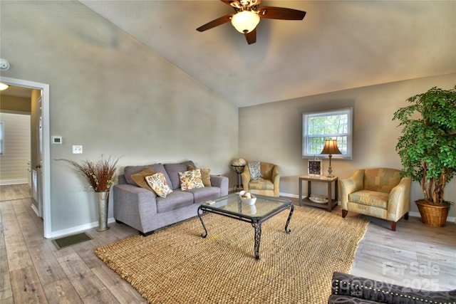 living room with vaulted ceiling, a ceiling fan, wood finished floors, baseboards, and visible vents