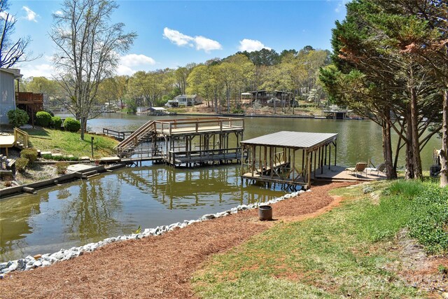 dock area with a water view and boat lift