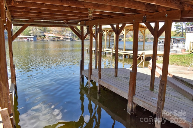view of dock featuring a water view and boat lift