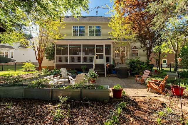 206 Coburn Ct, Fort Mill, SC 29715 - rear view of property featuring a garden, a sunroom, and a patio area