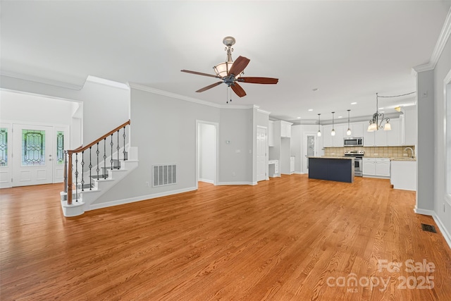 206 Coburn Ct, Fort Mill, SC 29715 - unfurnished living room featuring crown molding, ceiling fan, light wood finished floors, stairway, and recessed lighting