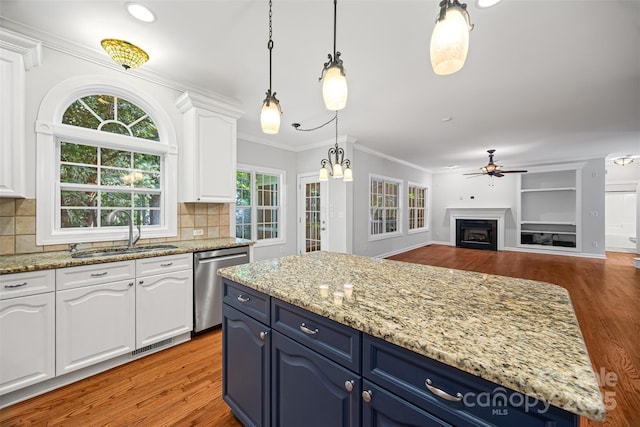 206 Coburn Ct, Fort Mill, SC 29715 - kitchen with stainless steel dishwasher, blue cabinets, a ceiling fan, white cabinets, and light wood-style flooring