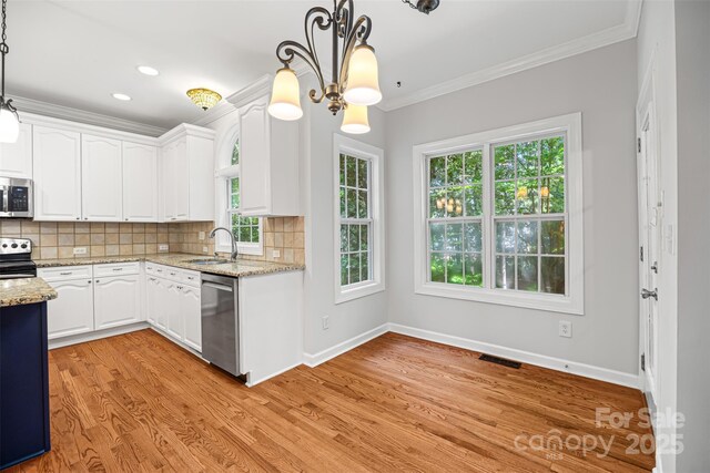 206 Coburn Ct, Fort Mill, SC 29715 - kitchen featuring stainless steel appliances, crown molding, white cabinetry, healthy amount of natural light, and a chandelier