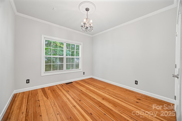 206 Coburn Ct, Fort Mill, SC 29715 - spare room featuring a chandelier, crown molding, and light wood-type flooring