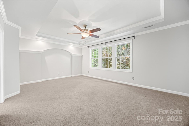 206 Coburn Ct, Fort Mill, SC 29715 - empty room featuring a tray ceiling, a ceiling fan, ornamental molding, and carpet