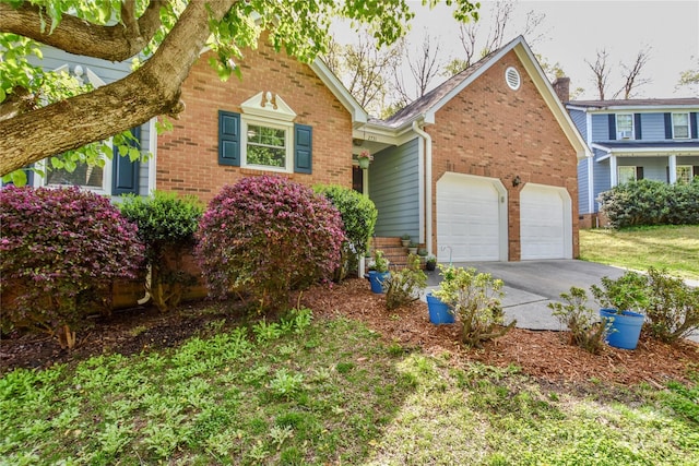 view of front of home with an attached garage, brick siding, and concrete driveway