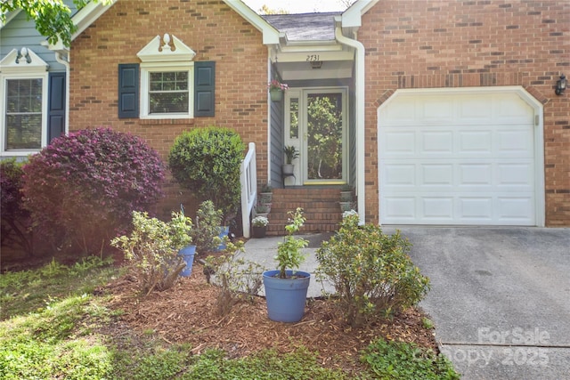 view of front facade with driveway, brick siding, and an attached garage