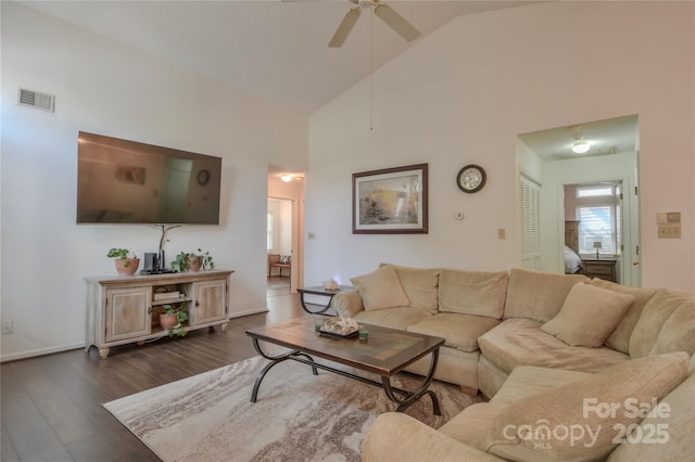 living area with high vaulted ceiling, baseboards, dark wood finished floors, visible vents, and a ceiling fan