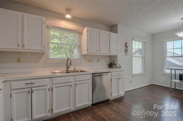 kitchen with a sink, dishwasher, plenty of natural light, white cabinets, and dark wood-type flooring