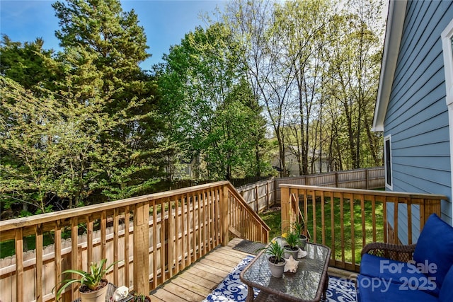 wooden terrace featuring a fenced backyard
