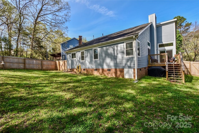 back of house featuring fence, a wooden deck, crawl space, a yard, and a chimney