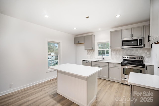 308 Birch St, Lowell, NC 28098 - kitchen with stainless steel appliances, a sink, gray cabinets, light wood-style floors, and recessed lighting
