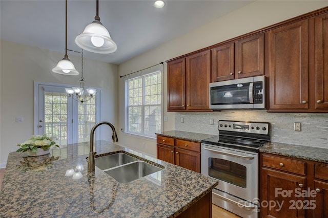 14103 Grand Traverse Dr, Charlotte, NC 28278 - kitchen featuring decorative backsplash, a sink, dark stone counters, and appliances with stainless steel finishes
