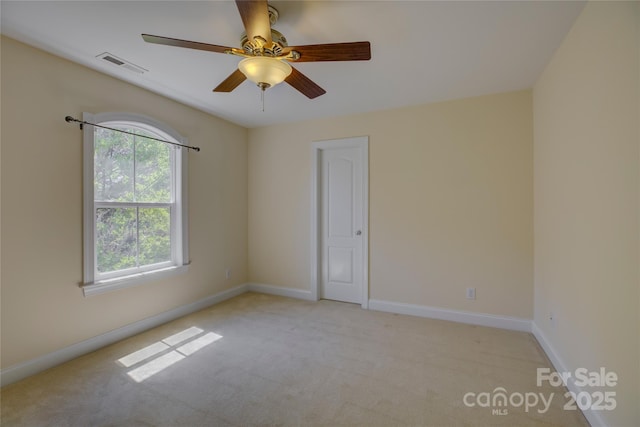 14103 Grand Traverse Dr, Charlotte, NC 28278 - empty room featuring baseboards, visible vents, light colored carpet, and a ceiling fan
