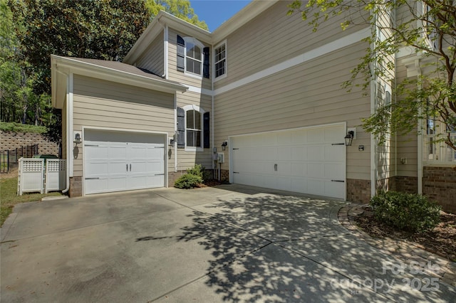 14103 Grand Traverse Dr, Charlotte, NC 28278 - view of property exterior with driveway, fence, and an attached garage