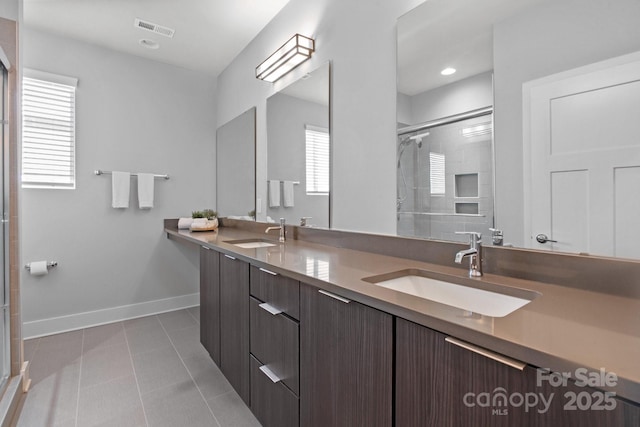 324 Uptown W Dr, Charlotte, NC 28208 - full bathroom with visible vents, a sink, tile patterned flooring, and a shower with shower door