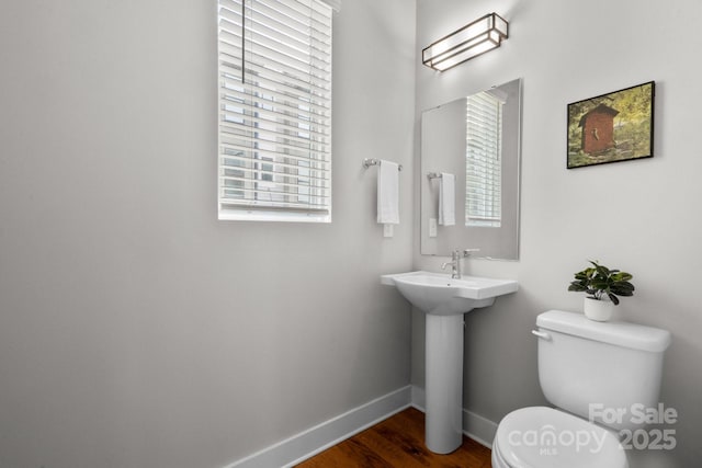 324 Uptown W Dr, Charlotte, NC 28208 - bathroom with baseboards, wood finished floors, and toilet