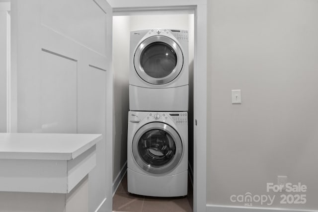 324 Uptown W Dr, Charlotte, NC 28208 - washroom with stacked washer / dryer, tile patterned floors, and laundry area