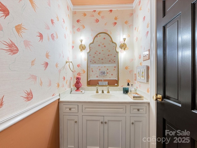 bathroom featuring ornamental molding, wallpapered walls, and vanity