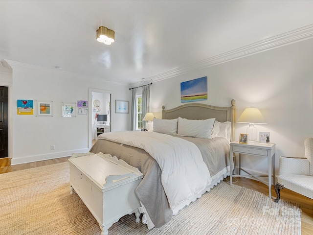 bedroom featuring baseboards, light wood-style floors, and crown molding
