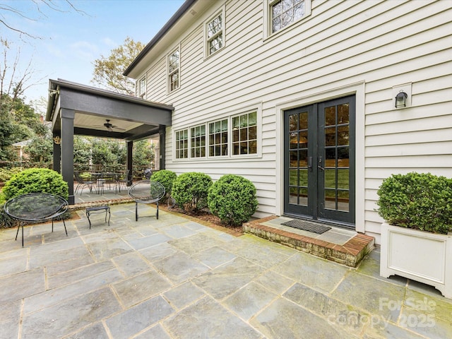 view of patio with french doors, outdoor dining space, and ceiling fan