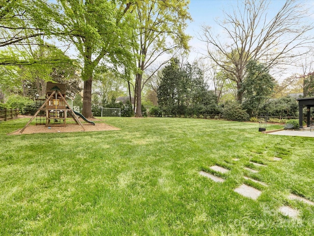view of yard with fence and a playground