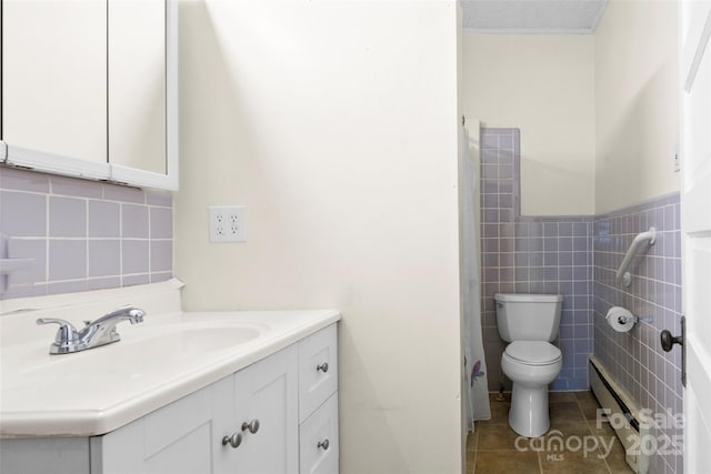bathroom featuring toilet, a baseboard radiator, tile walls, vanity, and tile patterned floors