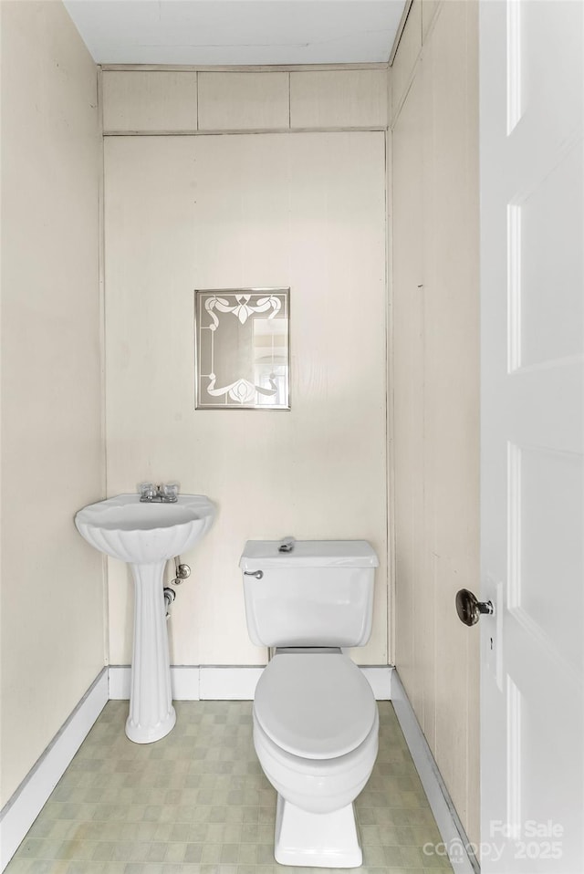 bathroom featuring toilet and tile patterned floors