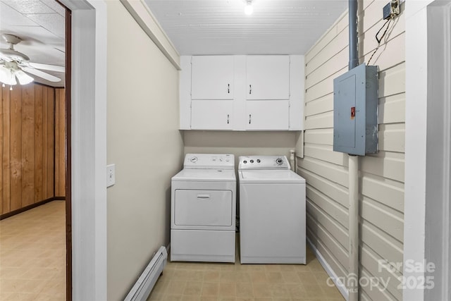 clothes washing area with ceiling fan, electric panel, baseboard heating, washing machine and clothes dryer, and cabinet space