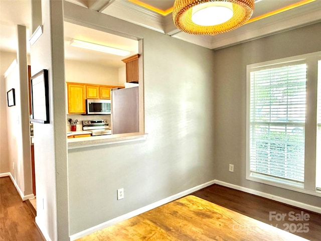 4130 Town Center Rd, Harrisburg, NC 28075 - kitchen featuring stainless steel appliances, wood finished floors, baseboards, light countertops, and crown molding