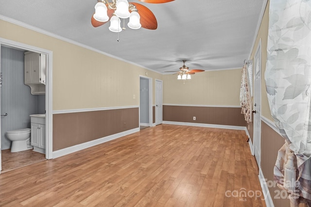 394 Efird St, Gastonia, NC 28054 - spare room featuring light wood-type flooring, a ceiling fan, and ornamental molding