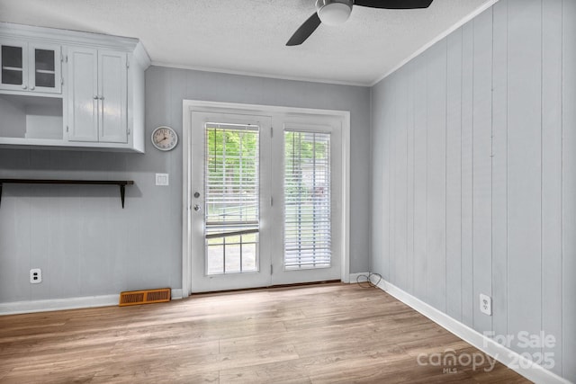 394 Efird St, Gastonia, NC 28054 - doorway to outside featuring a ceiling fan, a textured ceiling, light wood-type flooring, ornamental molding, and visible vents