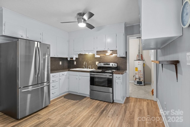 394 Efird St, Gastonia, NC 28054 - kitchen featuring dark countertops, a sink, appliances with stainless steel finishes, gas water heater, and under cabinet range hood