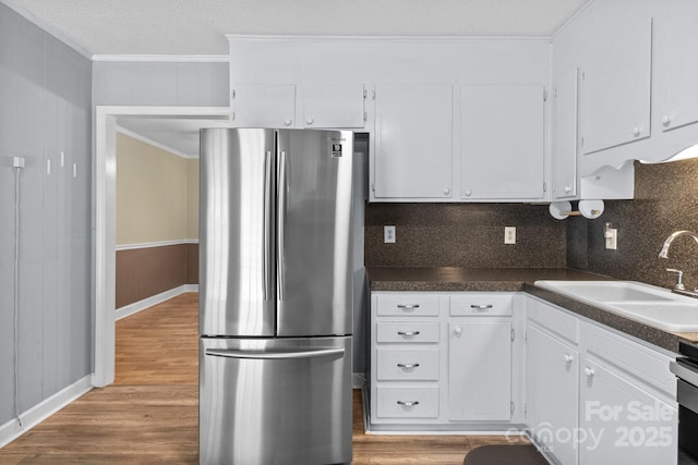 394 Efird St, Gastonia, NC 28054 - kitchen with white cabinets, ornamental molding, a sink, and freestanding refrigerator