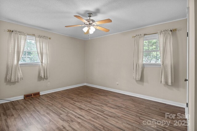 394 Efird St, Gastonia, NC 28054 - unfurnished room featuring wood finished floors, visible vents, a ceiling fan, and crown molding