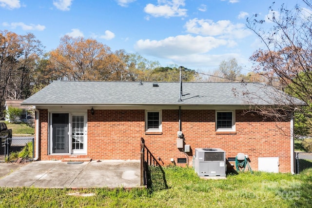 394 Efird St, Gastonia, NC 28054 - rear view of house featuring central AC unit, brick siding, fence, and roof with shingles
